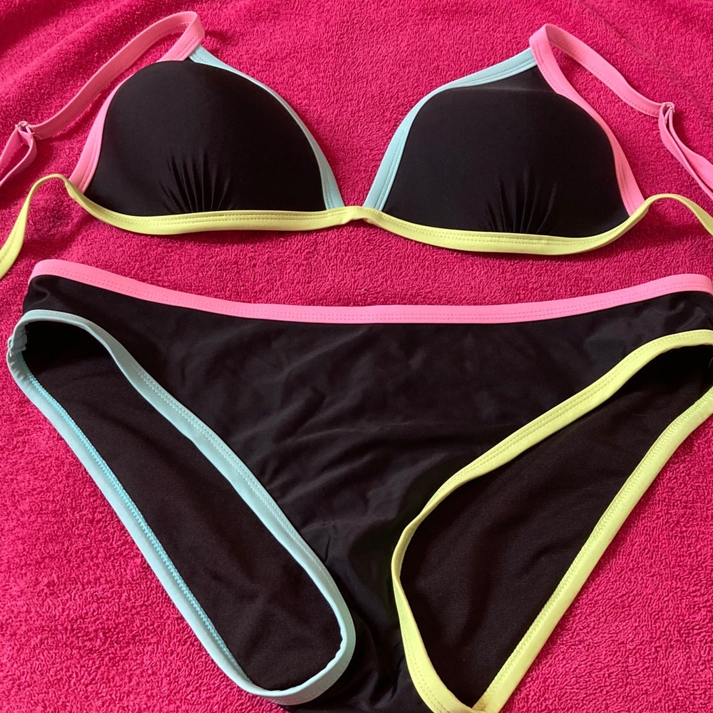 Cabana 2 piece suit each piece is an XXL. Black with trim of pink, lime and blu